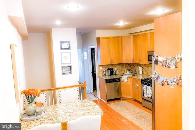 a kitchen with granite countertop a sink and stainless steel appliances