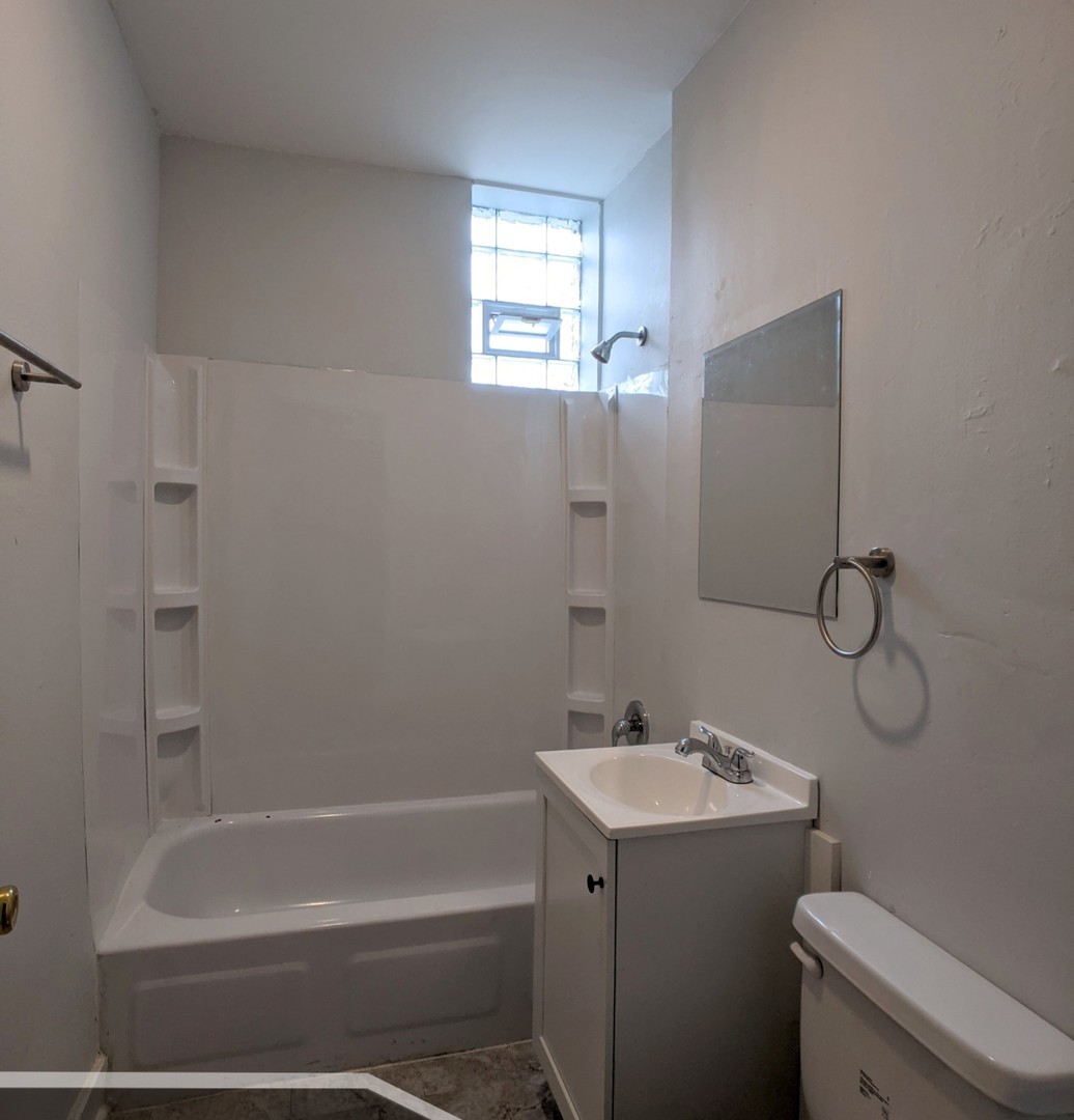 3544 North Halsted Street, Unit 2R Chicago, IL 60657 - Photo 12 of 13 a bathroom with a sink toilet and shower