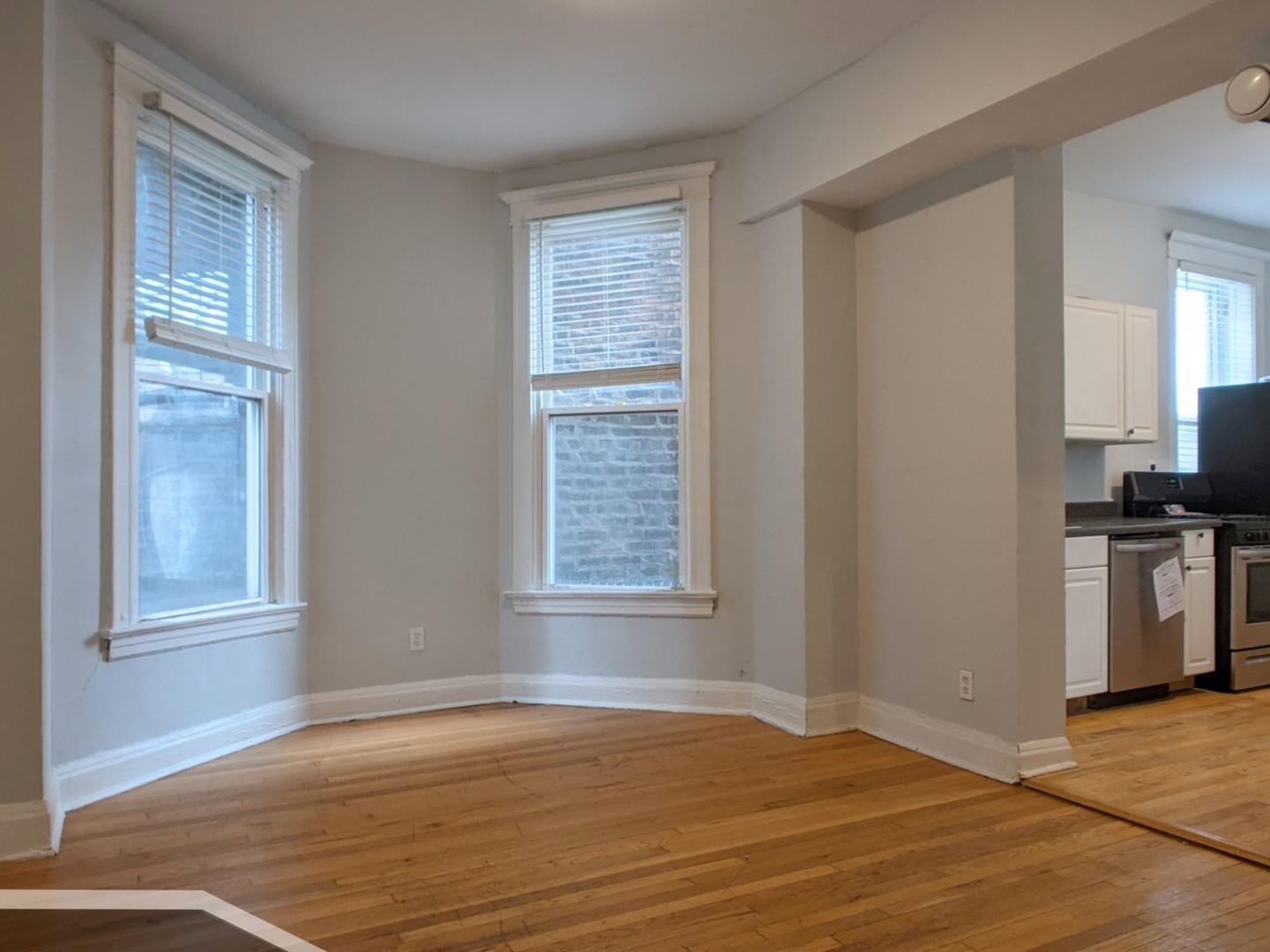 3544 North Halsted Street, Unit 2R Chicago, IL 60657 - Photo 2 of 13 a view of an empty room with a kitchen and a window