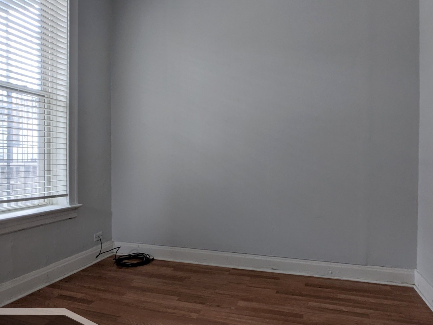 3544 North Halsted Street, Unit 2R Chicago, IL 60657 - Photo 6 of 13 a view of an empty room with wooden floor and a window