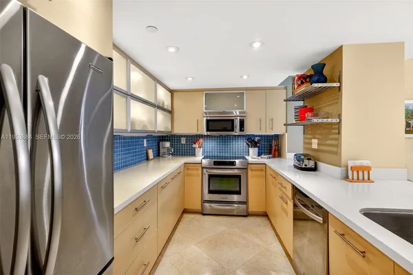 a kitchen with sink a stove and cabinets