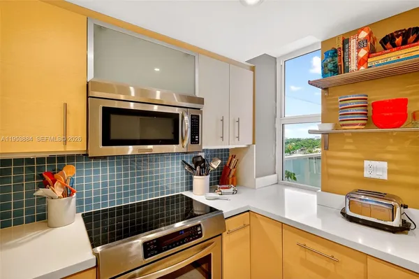 a kitchen with stainless steel appliances a sink and a refrigerator