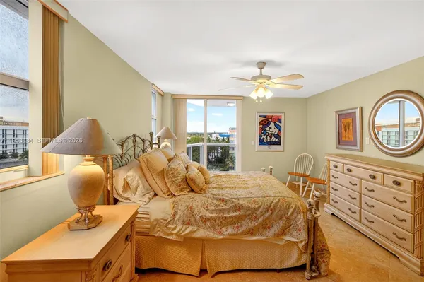 a bathroom with a granite countertop sink a toilet and a mirror