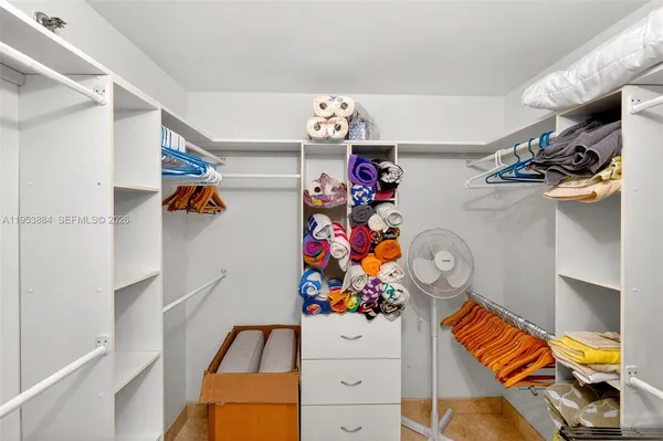 a bedroom with a large bed and a large window