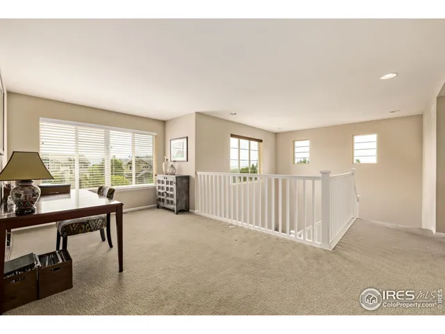 a view of a livingroom with furniture and a window