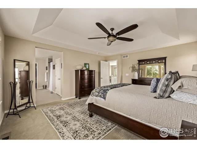 a bedroom with a bed and a large mirror