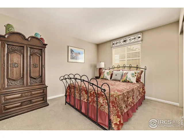 a bedroom with furniture and wooden floor