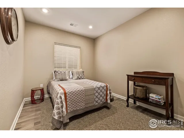 a bedroom with a bed a fireplace and a television