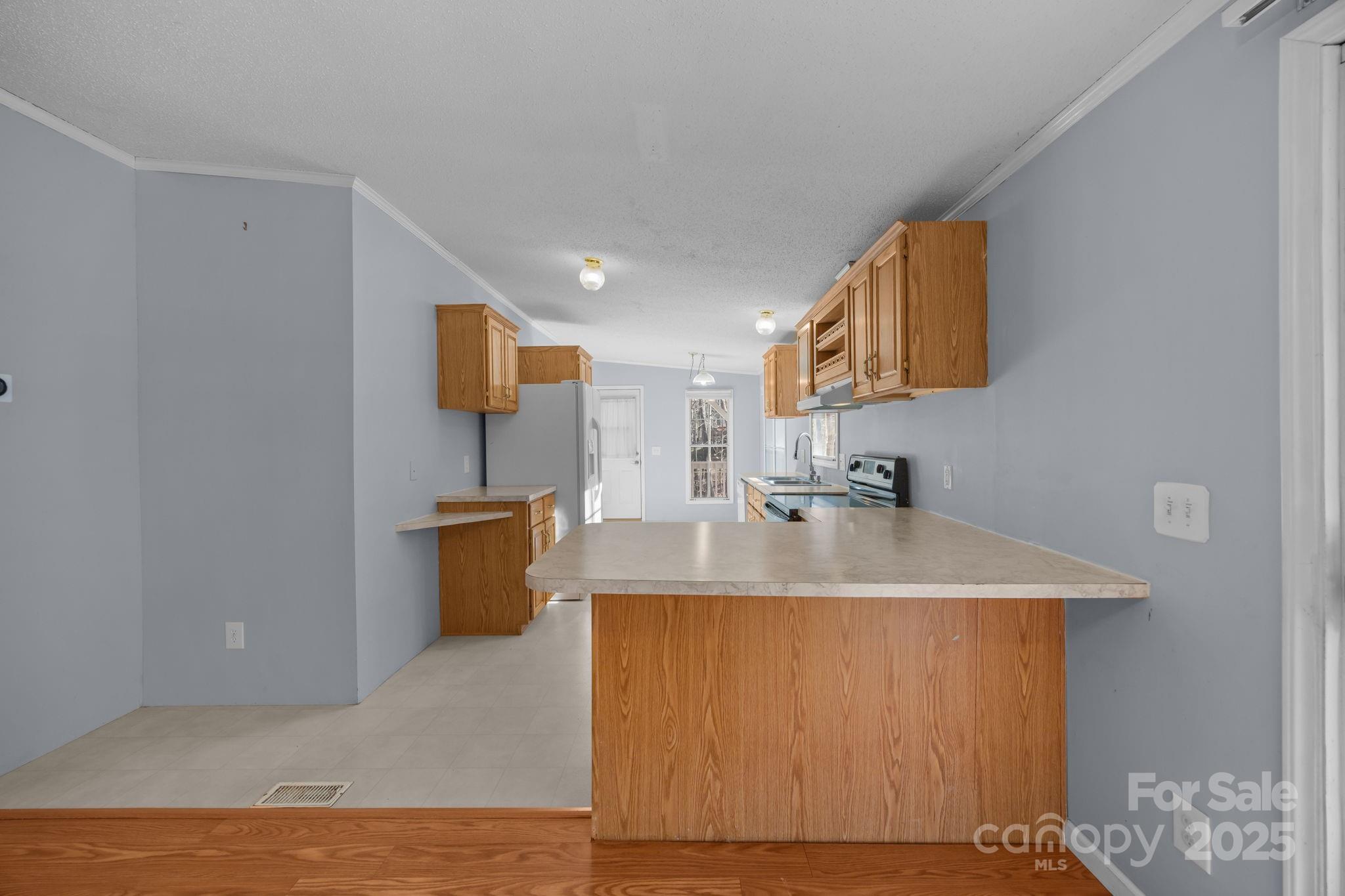 5043 Pebble Stone Road Maiden, NC 28650 - Photo 28 of 46 a kitchen with stainless steel appliances granite countertop a sink a stove top oven a counter space and cabinets