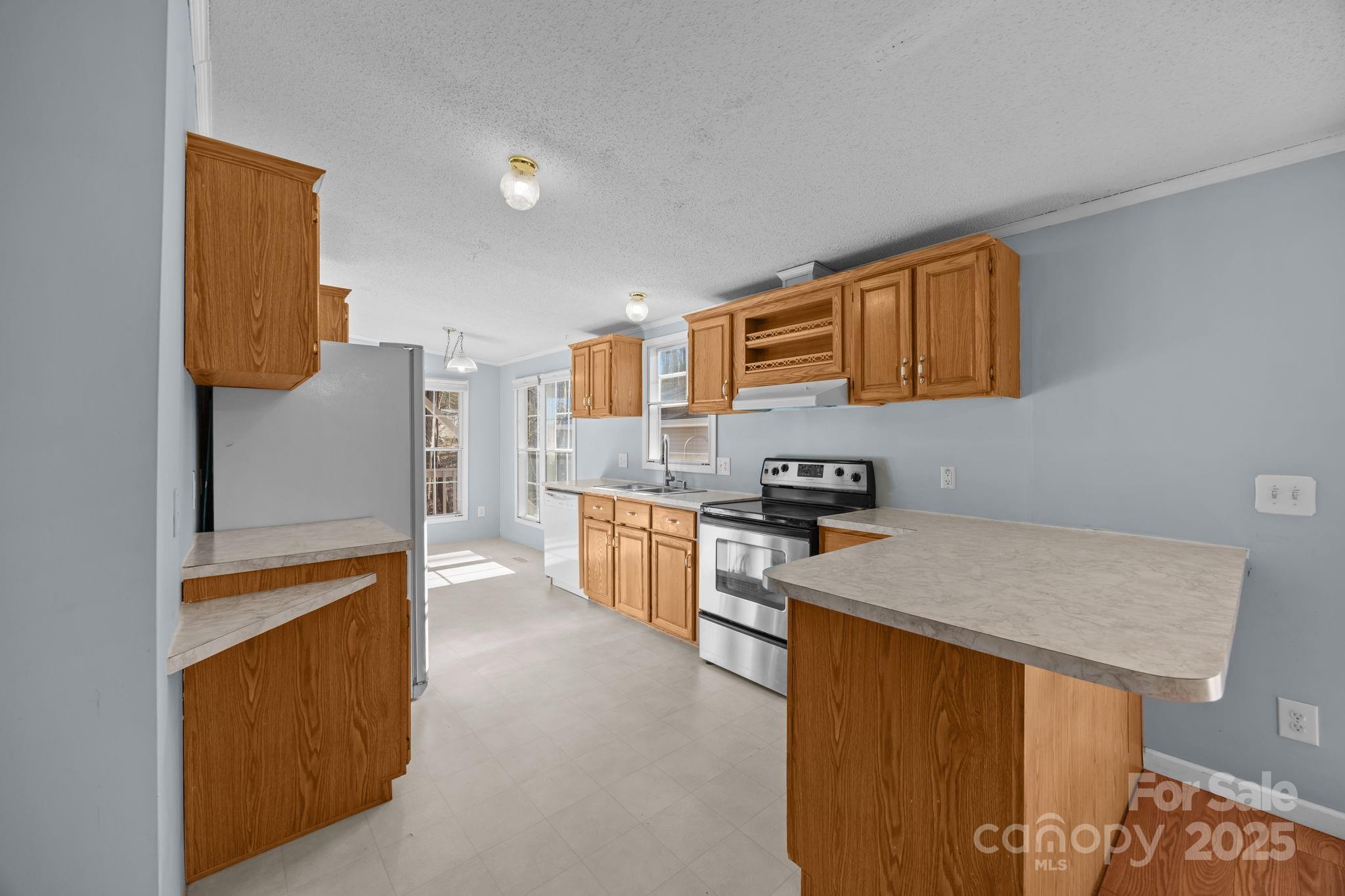5043 Pebble Stone Road Maiden, NC 28650 - Photo 29 of 46 a kitchen with stainless steel appliances granite countertop a sink stove and refrigerator