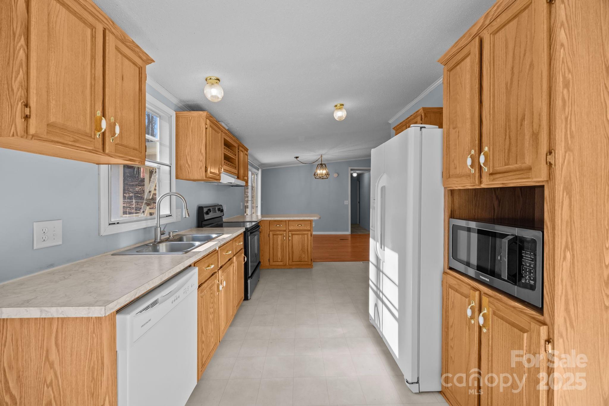 5043 Pebble Stone Road Maiden, NC 28650 - Photo 30 of 46 a kitchen with stainless steel appliances granite countertop a refrigerator a stove and a sink