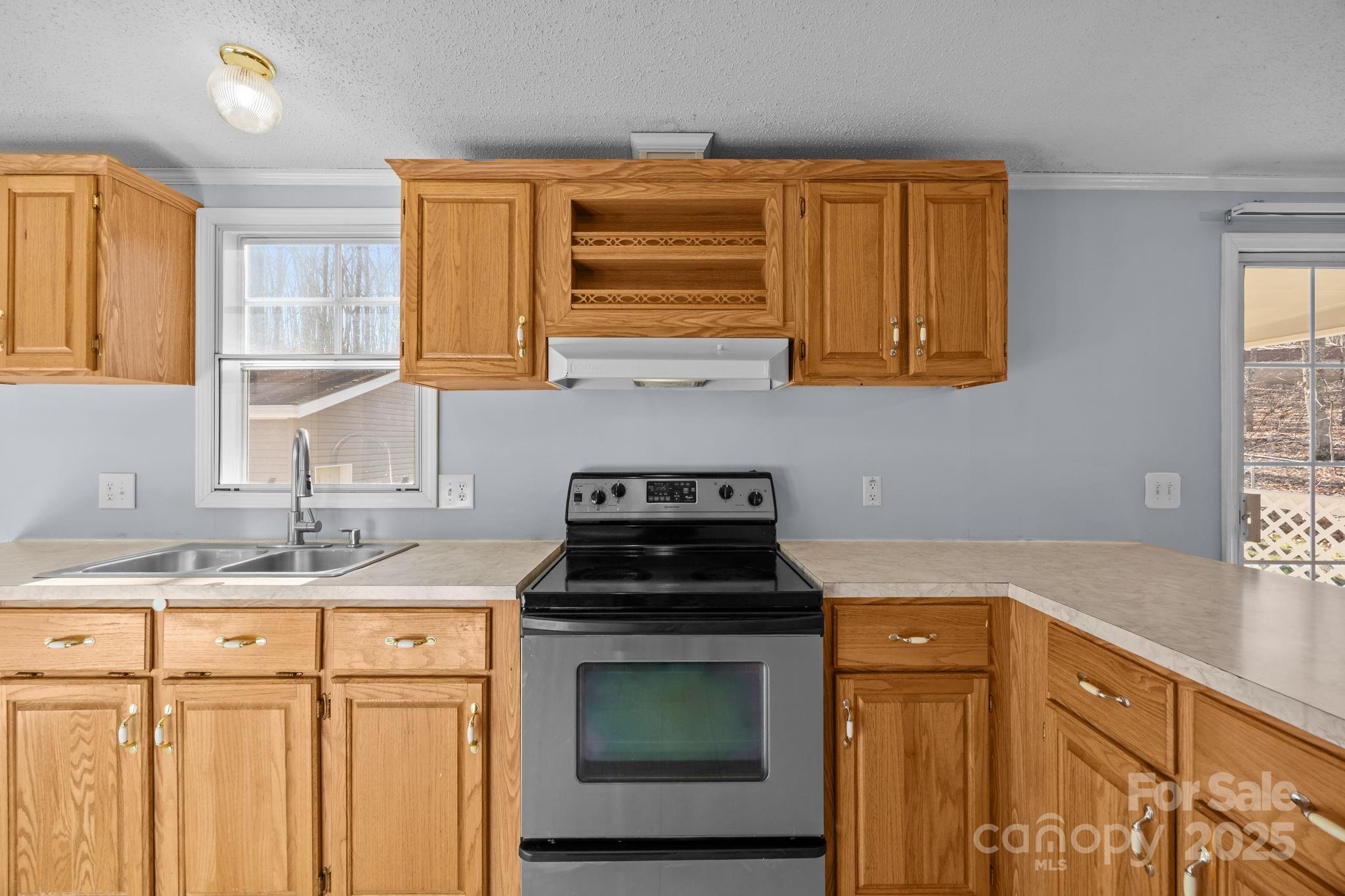 5043 Pebble Stone Road Maiden, NC 28650 - Photo 32 of 46 a kitchen with granite countertop a sink a stove and cabinets