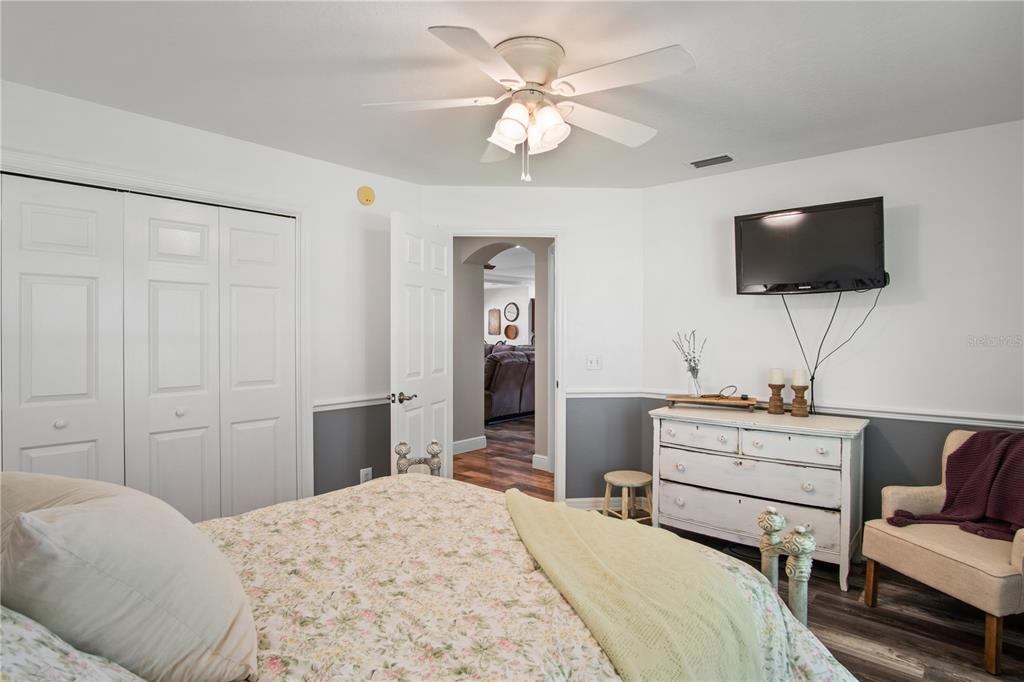 9045 Lake Hatchineha Road Kissimmee, FL 34759 - Photo 33 of 47 a bedroom with a bed and a flat screen tv