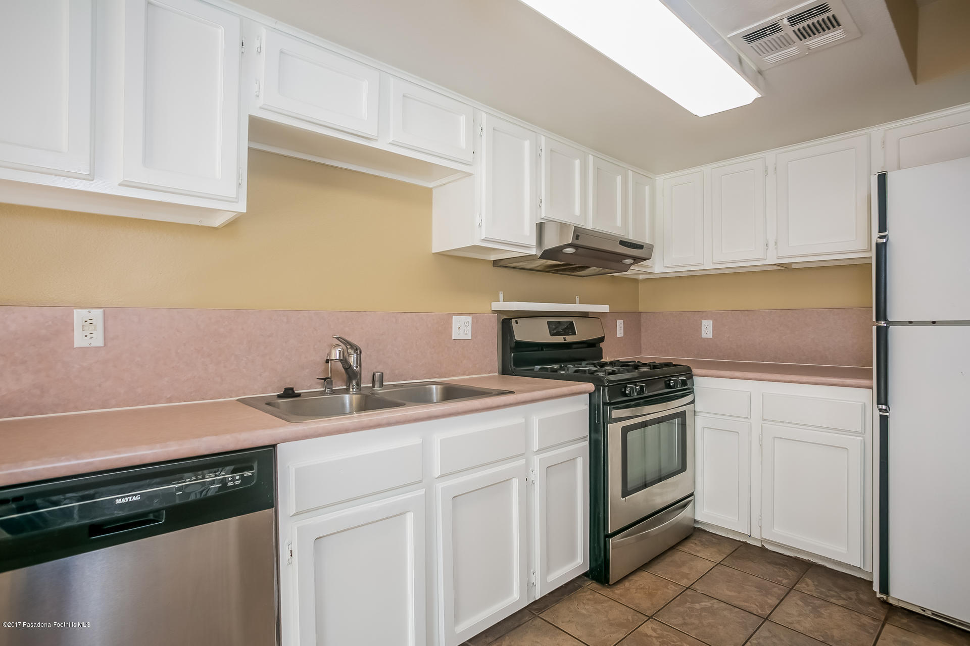 248 East Washington Boulevard, Unit 4 Pasadena, CA 91104 - Photo 3 of 19 a kitchen with stainless steel appliances granite countertop a sink stove and refrigerator
