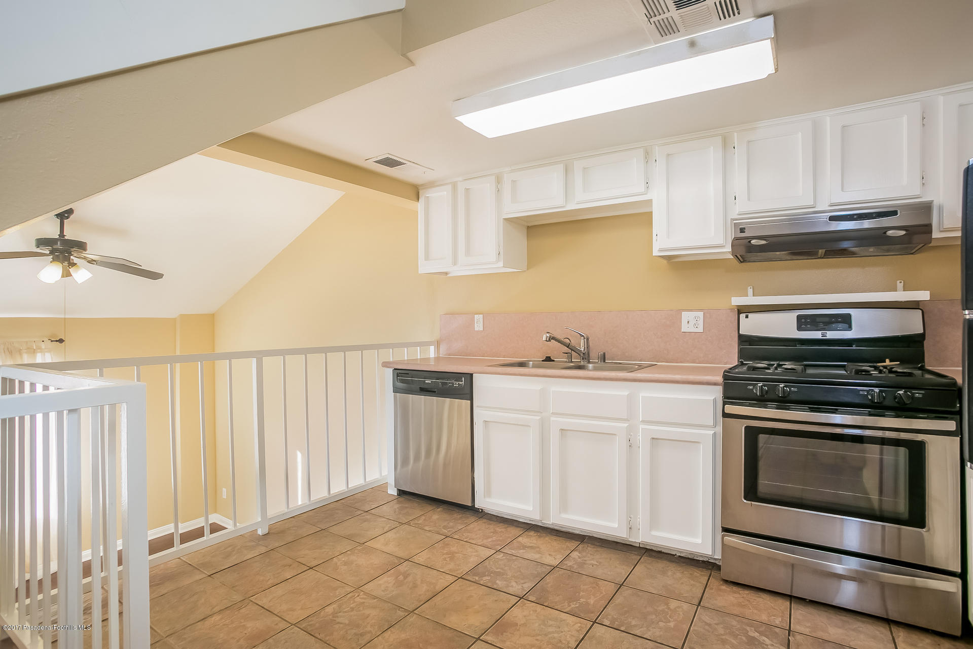 248 East Washington Boulevard, Unit 4 Pasadena, CA 91104 - Photo 4 of 19 a kitchen with granite countertop a stove top oven sink and cabinets