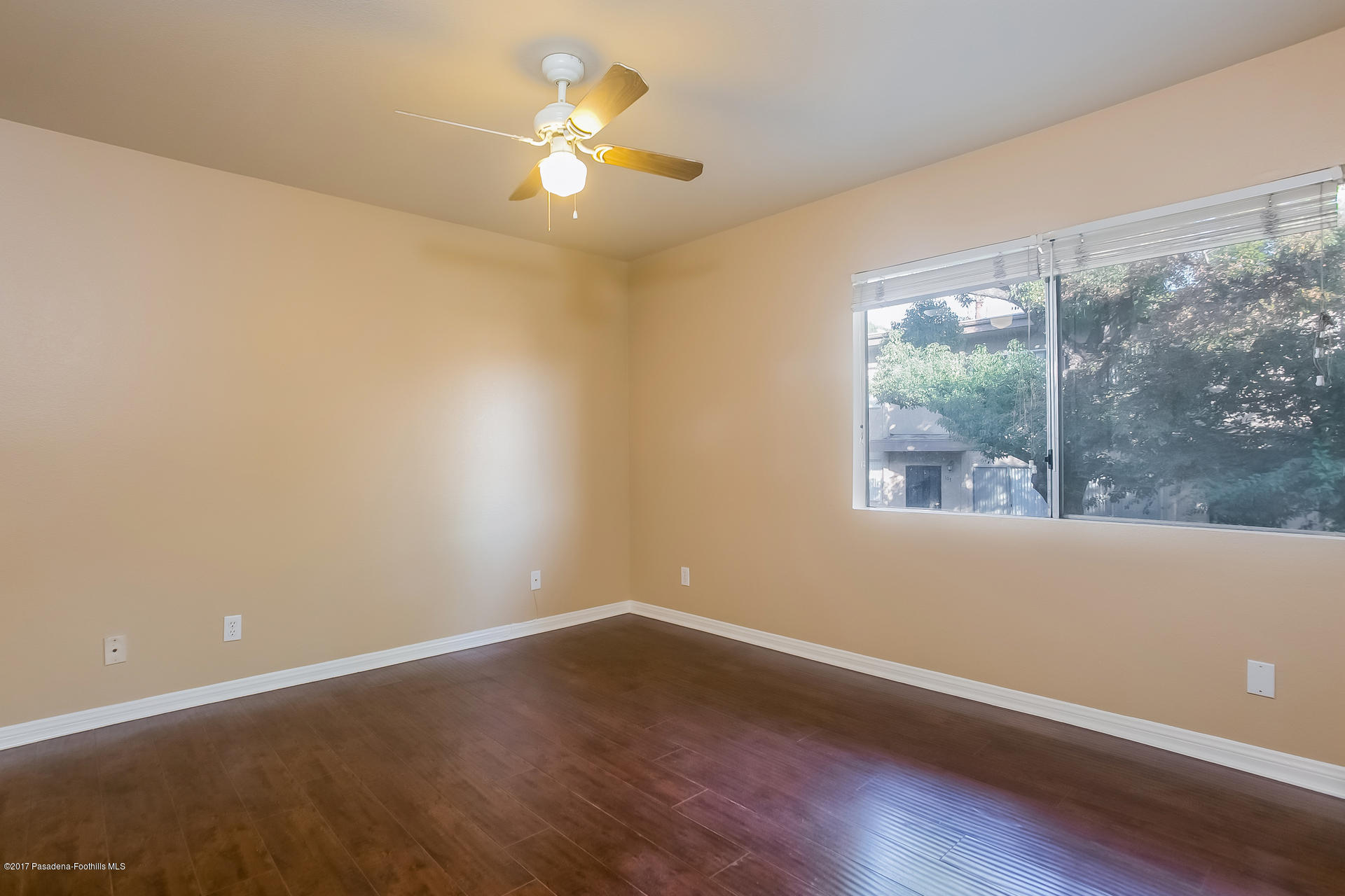 248 East Washington Boulevard, Unit 4 Pasadena, CA 91104 - Photo 7 of 19 en empty room with wooden floor and windows