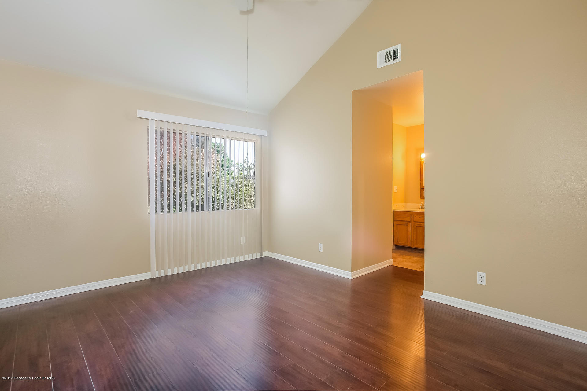 248 East Washington Boulevard, Unit 4 Pasadena, CA 91104 - Photo 10 of 19 an empty room with wooden floor and windows