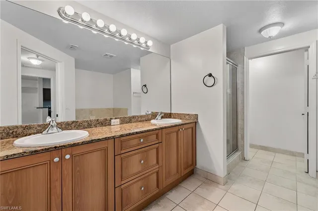 an empty room with a ceiling fan and a bathroom