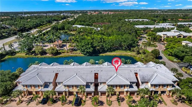 an aerial view of a house with a yard swimming pool and outdoor seating