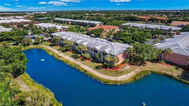 an aerial view of a house with a yard and lake view