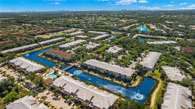 an aerial view of a house with a garden and lake view