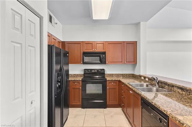 a kitchen that has a refrigerator and a sink