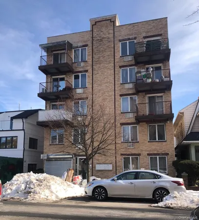a front view of a residential apartment building with a yard