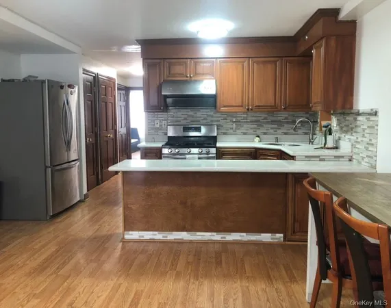 a kitchen with kitchen island granite countertop a sink appliances and cabinets