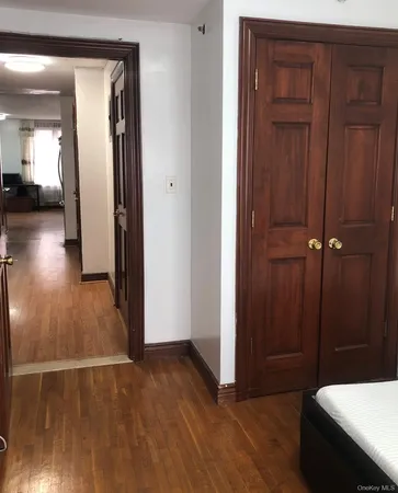 a view of a hallway with wooden floor