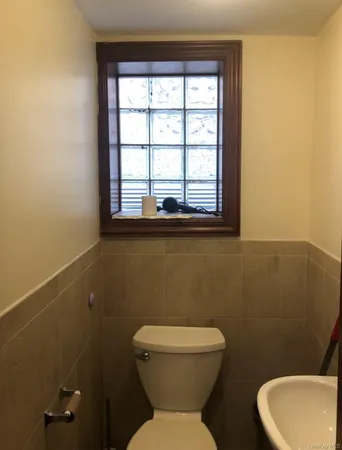 a white toilet sitting next to a window