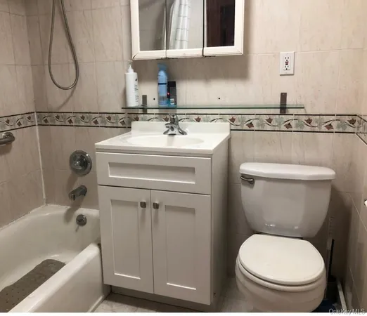 a bathroom with a sink a toilet and bathtub
