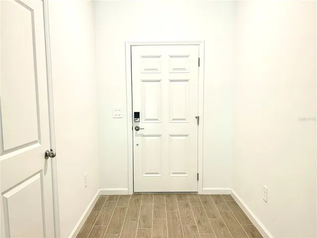 a view of a room with wooden floor