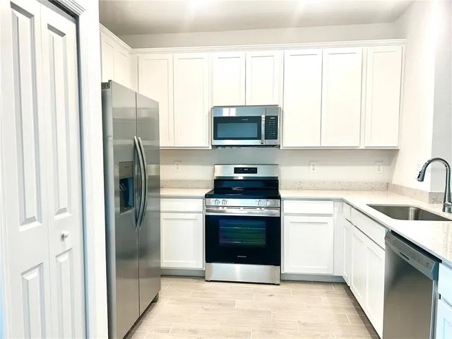 a kitchen with a refrigerator sink and microwave