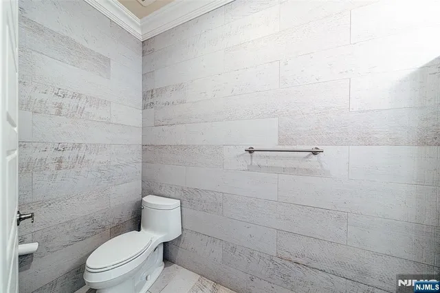 a white toilet sitting next to a bath tub