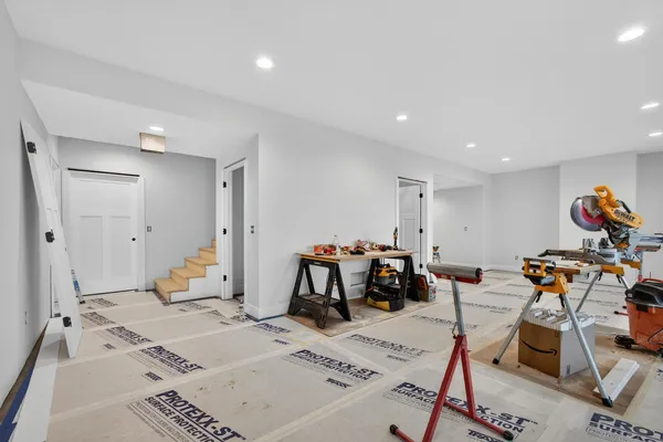 a living room with furniture and gym equipment
