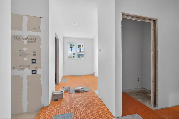 a bedroom with a bed and glass door