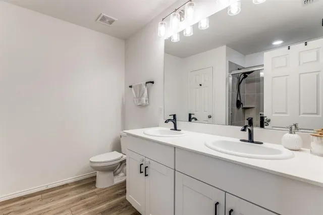 a bathroom with a sink a toilet and a mirror