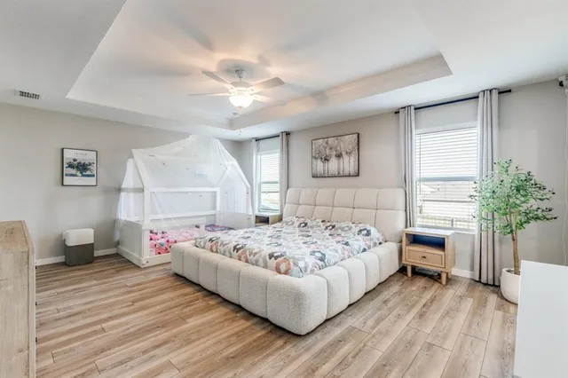 a bedroom with a bed and a chandelier