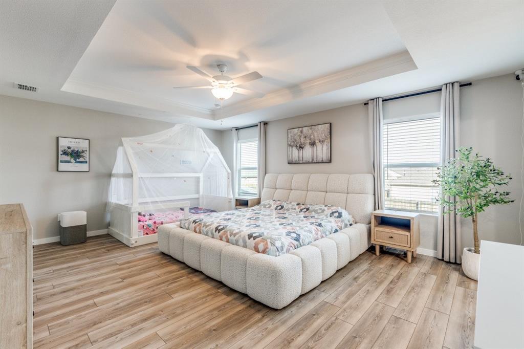 14033 Gaskin Street Pilot Point, TX 76258 - Photo 4 of 12 a bedroom with a bed and a chandelier