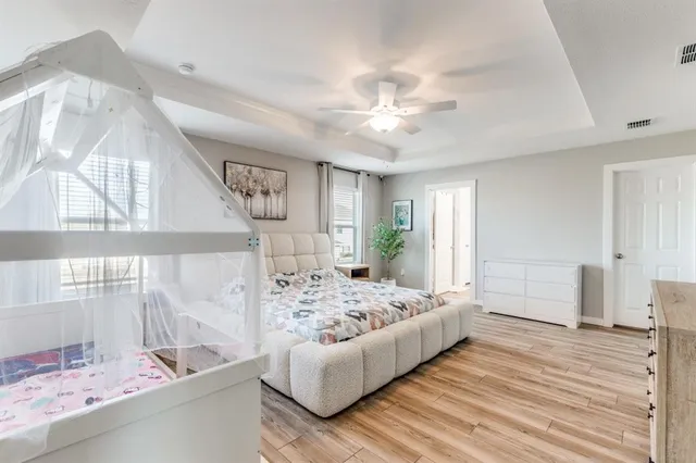 a bedroom with a large bed and a window