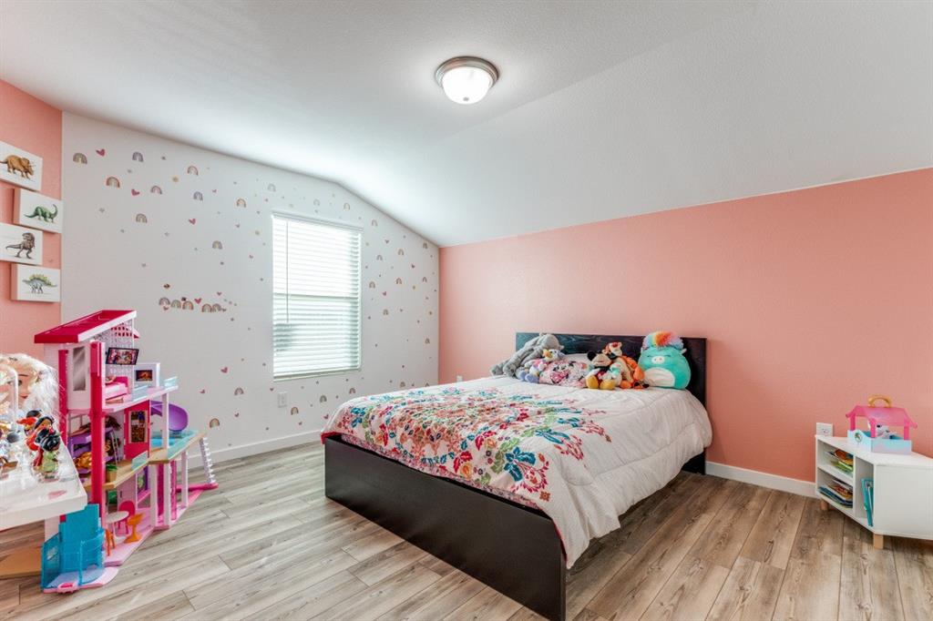 14033 Gaskin Street Pilot Point, TX 76258 - Photo 7 of 12 a bedroom with a bed and a window