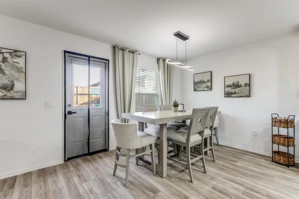a view of a dining room with furniture and wooden floor
