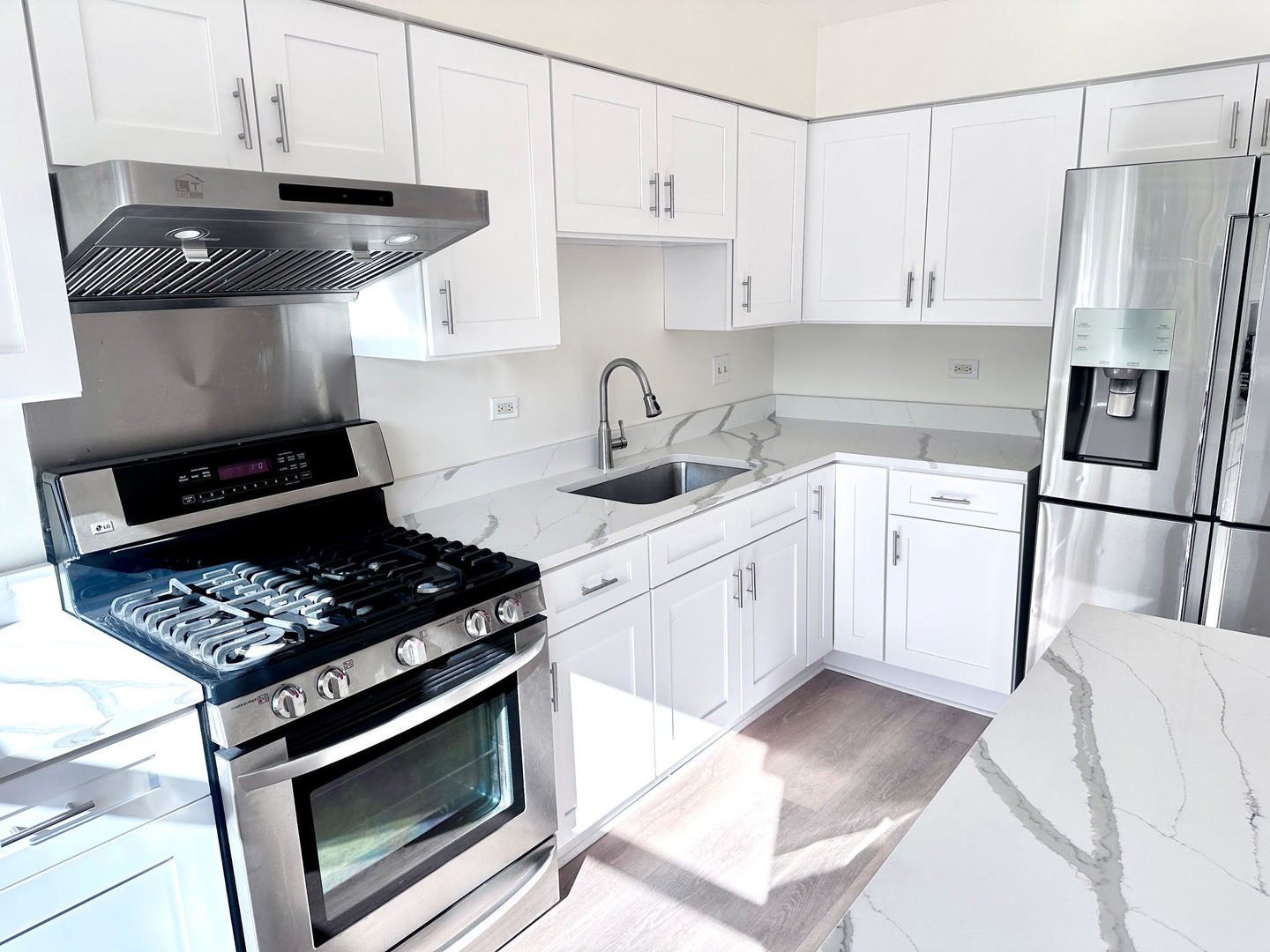 611 West 25th Place Chicago, IL 60616 - Photo 3 of 11 a kitchen with white cabinets and appliances