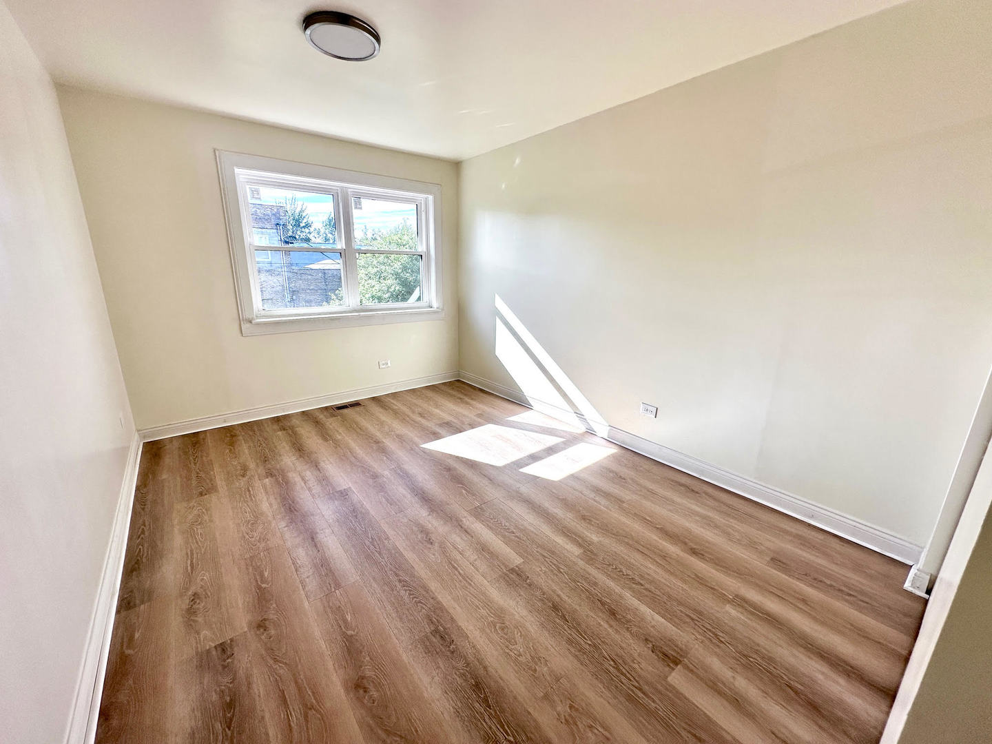 611 West 25th Place Chicago, IL 60616 - Photo 7 of 11 wooden floor in an empty room with a window