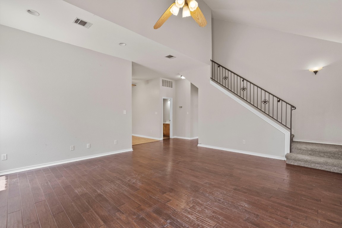 25600 Ronald Reagan Boulevard Georgetown, TX 78633 - Photo 17 of 36 a view of an empty room with wooden floor and stairs