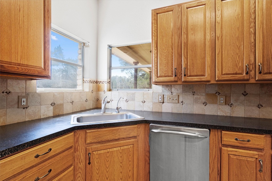 25600 Ronald Reagan Boulevard Georgetown, TX 78633 - Photo 21 of 36 a kitchen with granite countertop stainless steel appliances a sink window and cabinets