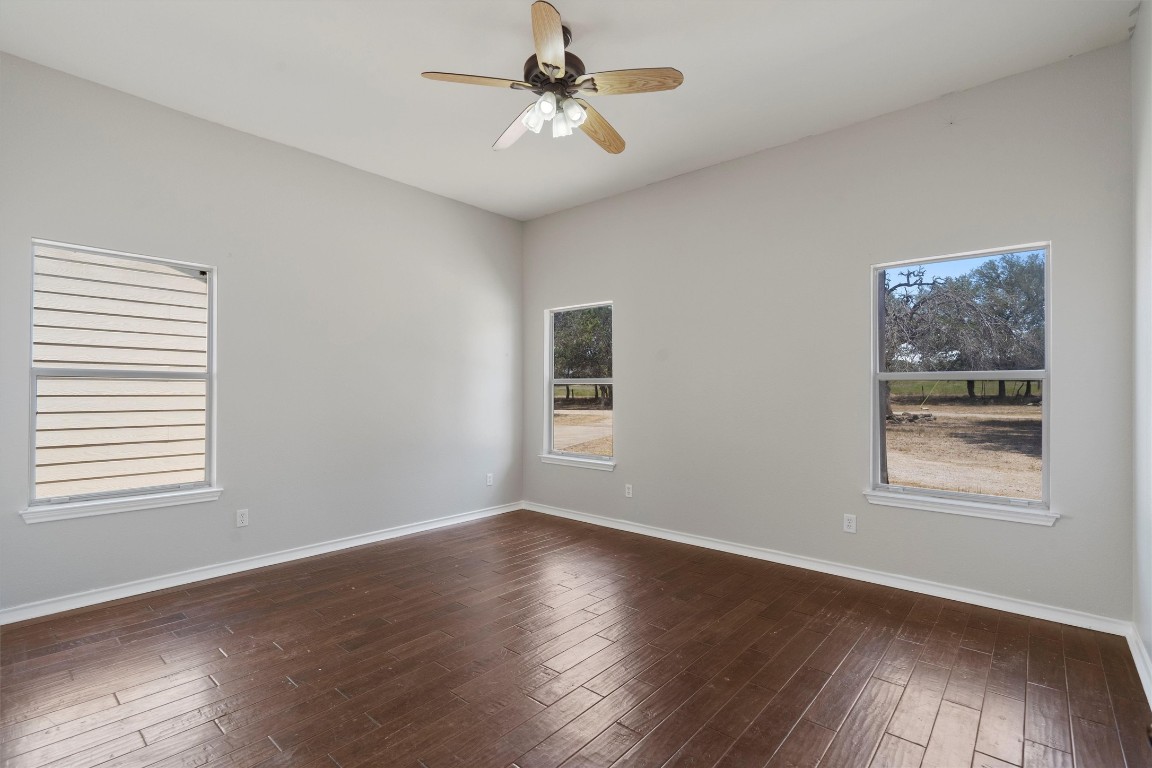 25600 Ronald Reagan Boulevard Georgetown, TX 78633 - Photo 23 of 36 a view of an empty room with wooden floor and a window