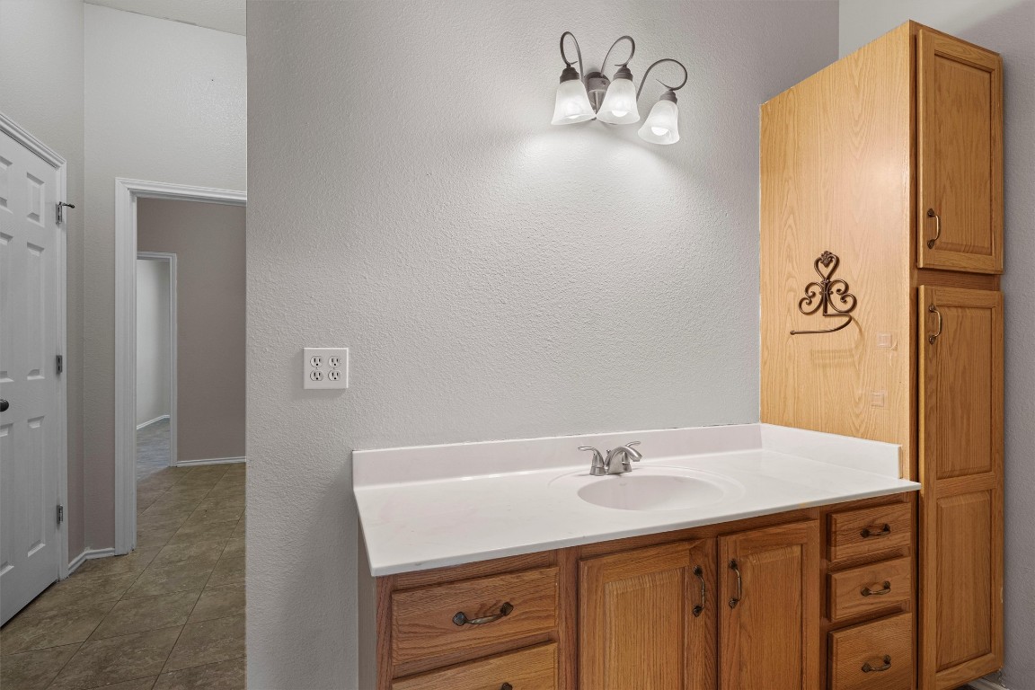 25600 Ronald Reagan Boulevard Georgetown, TX 78633 - Photo 24 of 36 a bathroom with a sink and a mirror