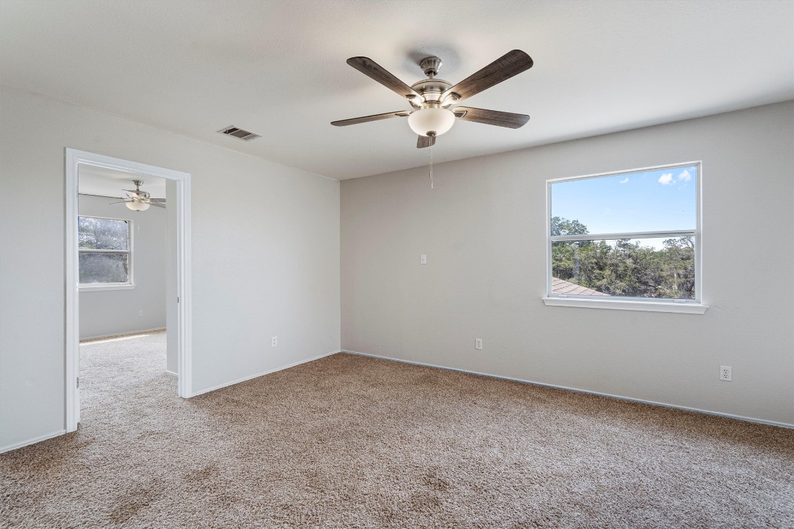 25600 Ronald Reagan Boulevard Georgetown, TX 78633 - Photo 27 of 36 an empty room with a window and ceiling fan
