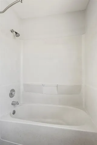 a view of a porch with wooden floor and fence